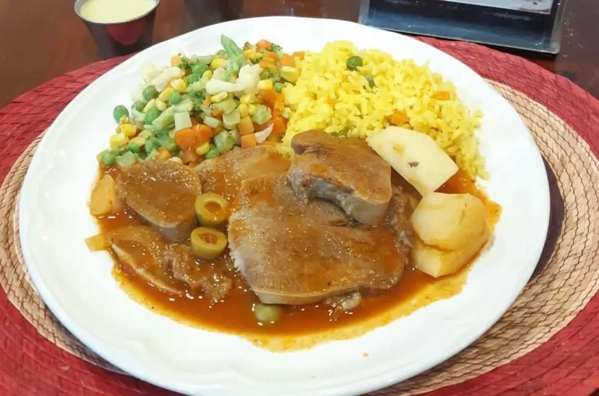 Lengua en salsa con aceitunas y papas, arroz amarillo y verduras